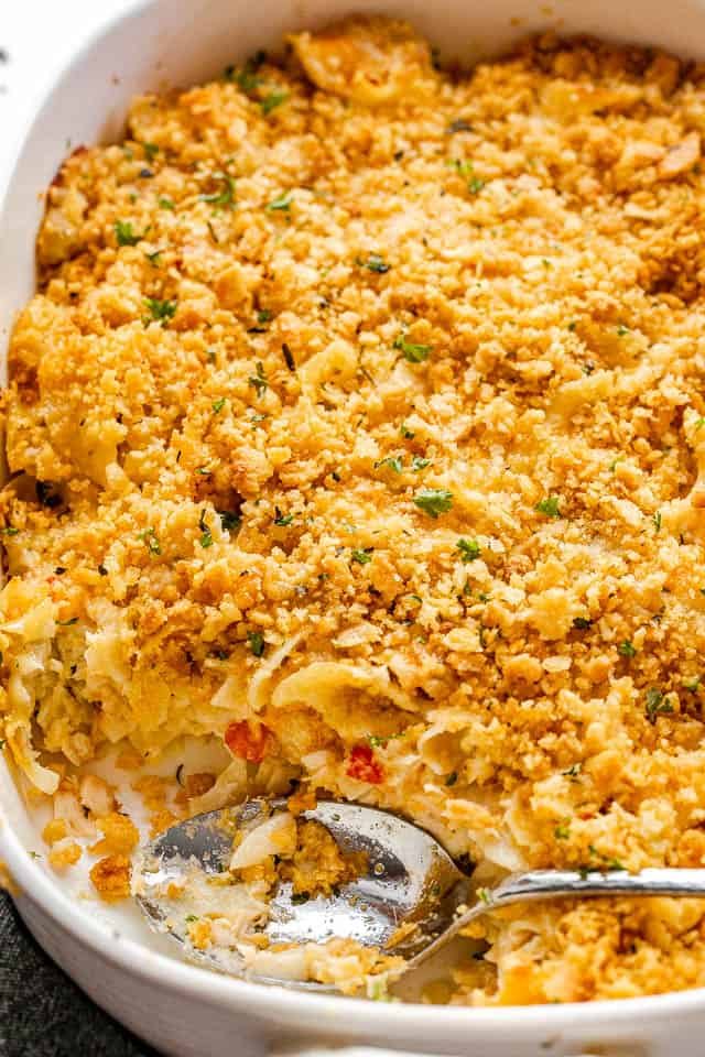 top side shot of a serving spoon inside a baking dish with tuna noodle casserole