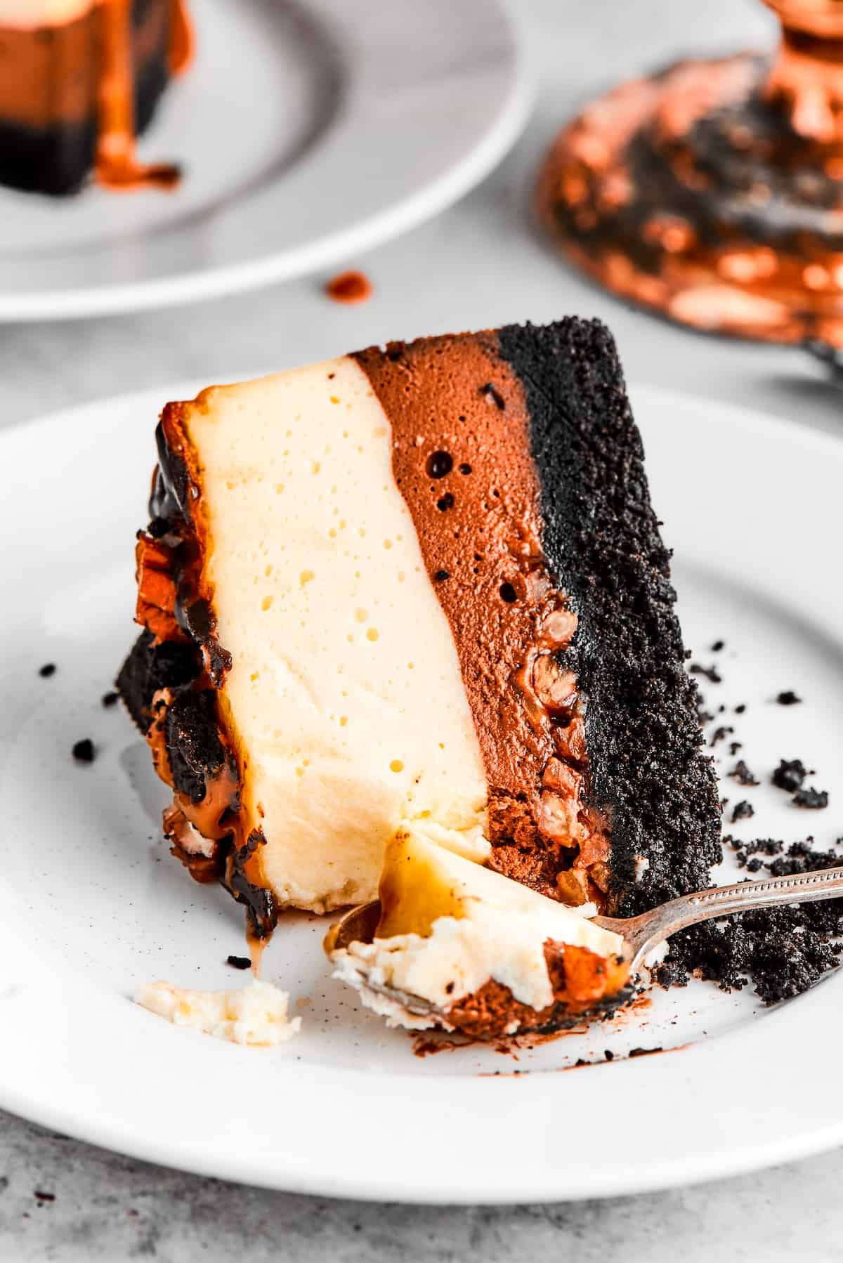 A slice of turtle cheesecake served on a dessert plate.