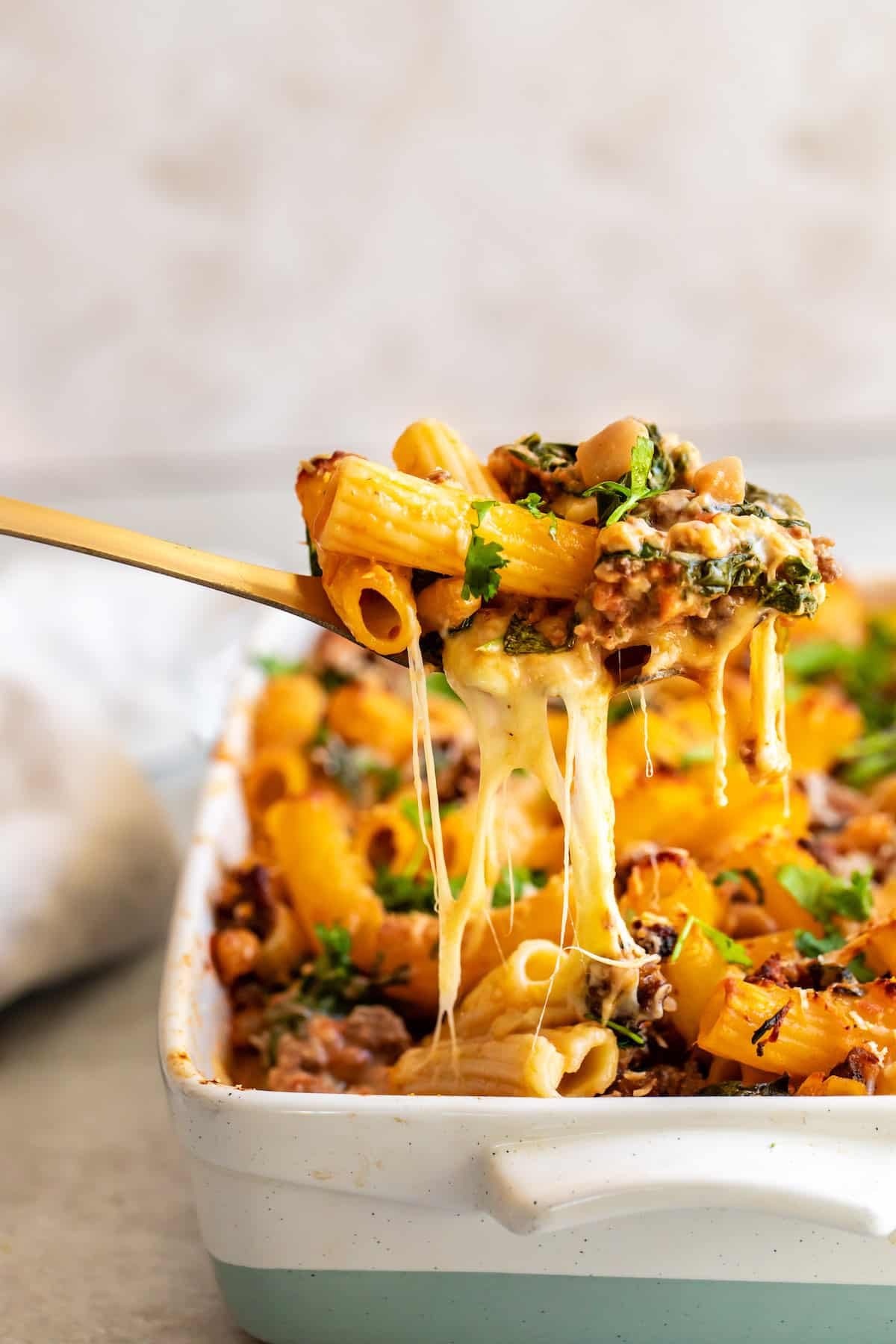 A Spoonful of Rigatoni Casserole Being Lifted From the Pan