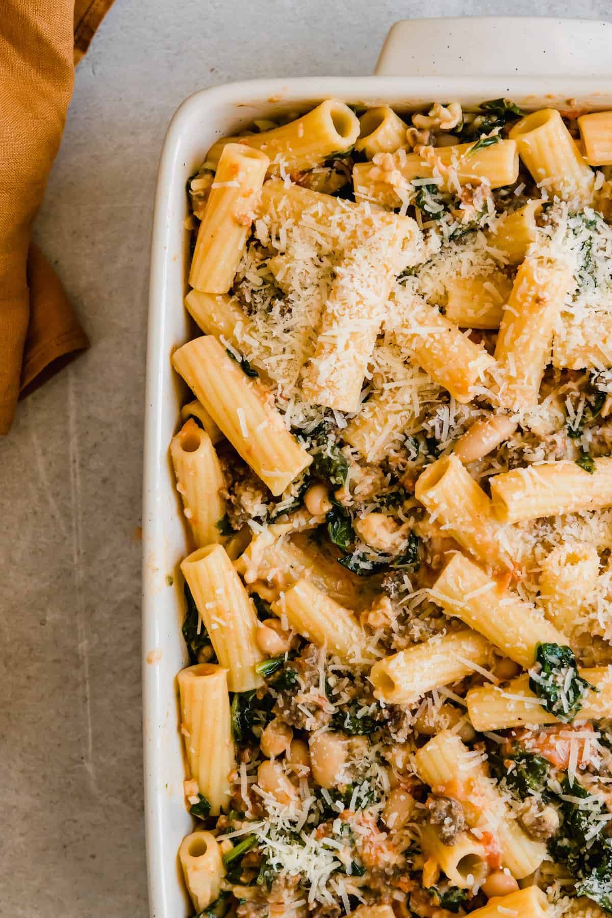 An Unbaked Rigatoni Casserole Topped with Shredded Cheese