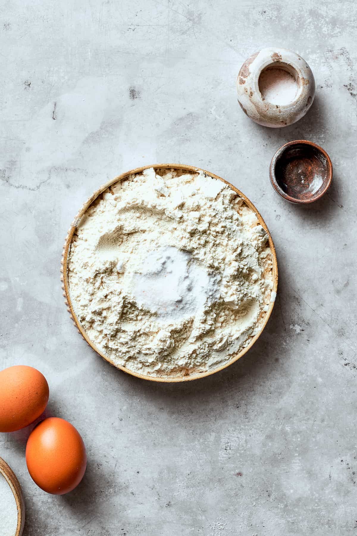 The dry mix for white chocolate chip cookie dough is added to a bowl.