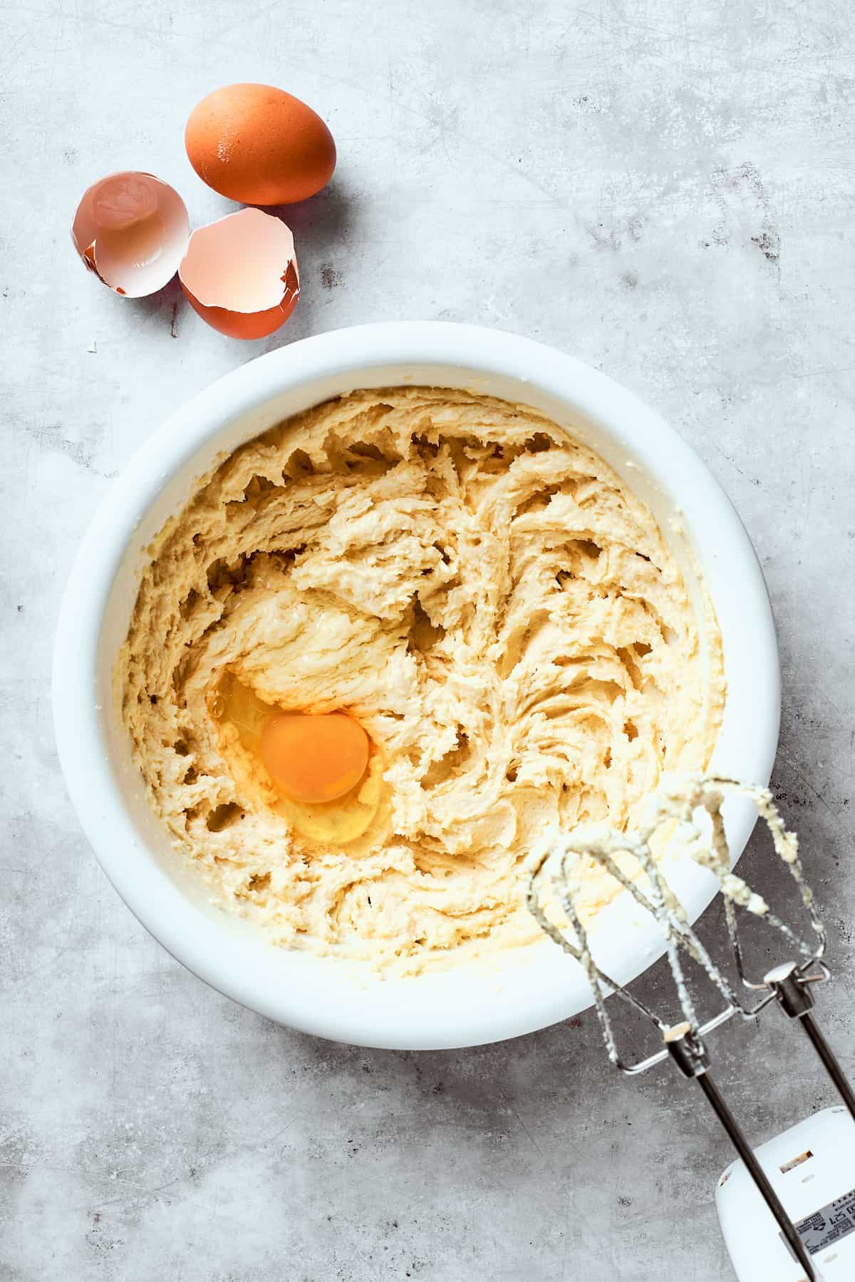 An egg is beaten into the butter-sugar mixture.