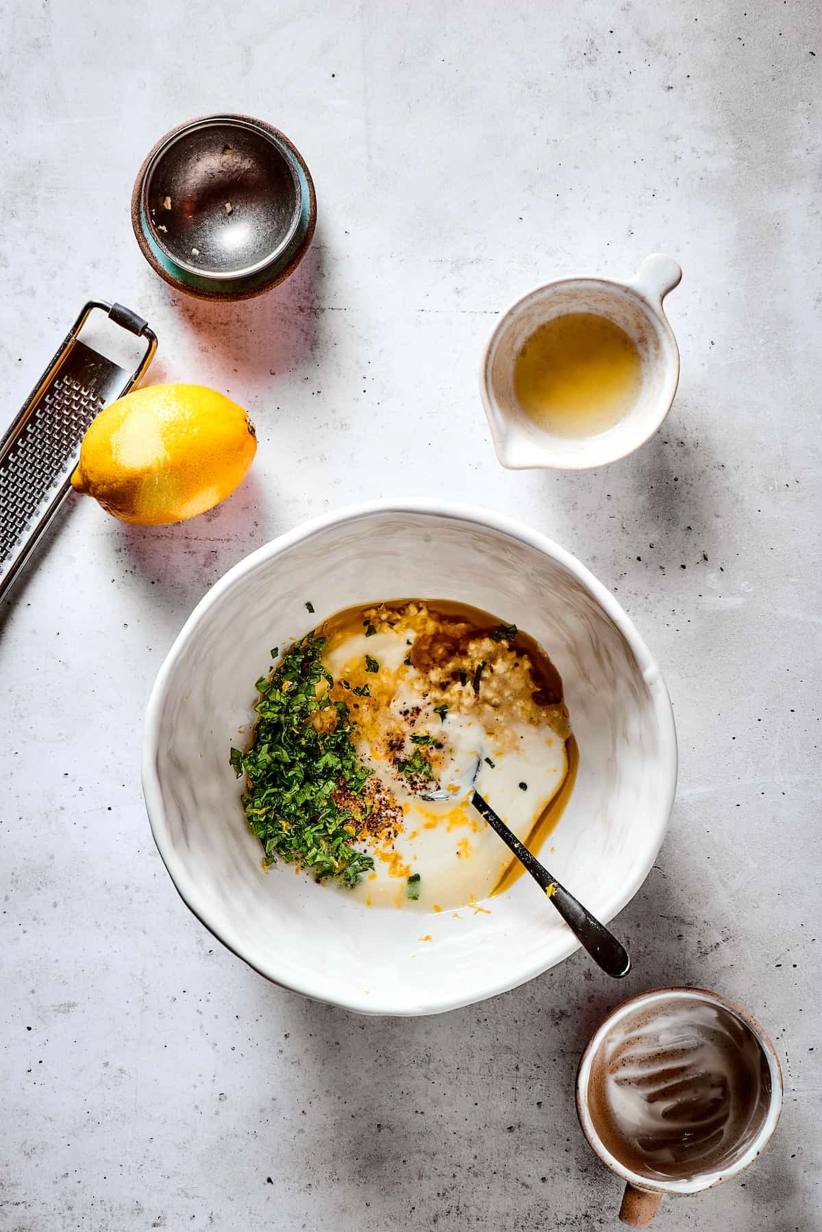 Mixing marinade ingredients in a white bowl.