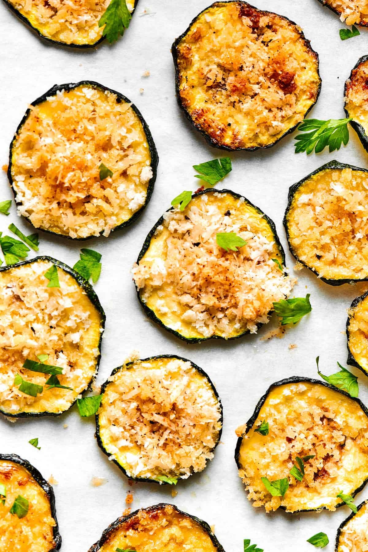 Slices of baked zucchini arranged neatly on a light surface.