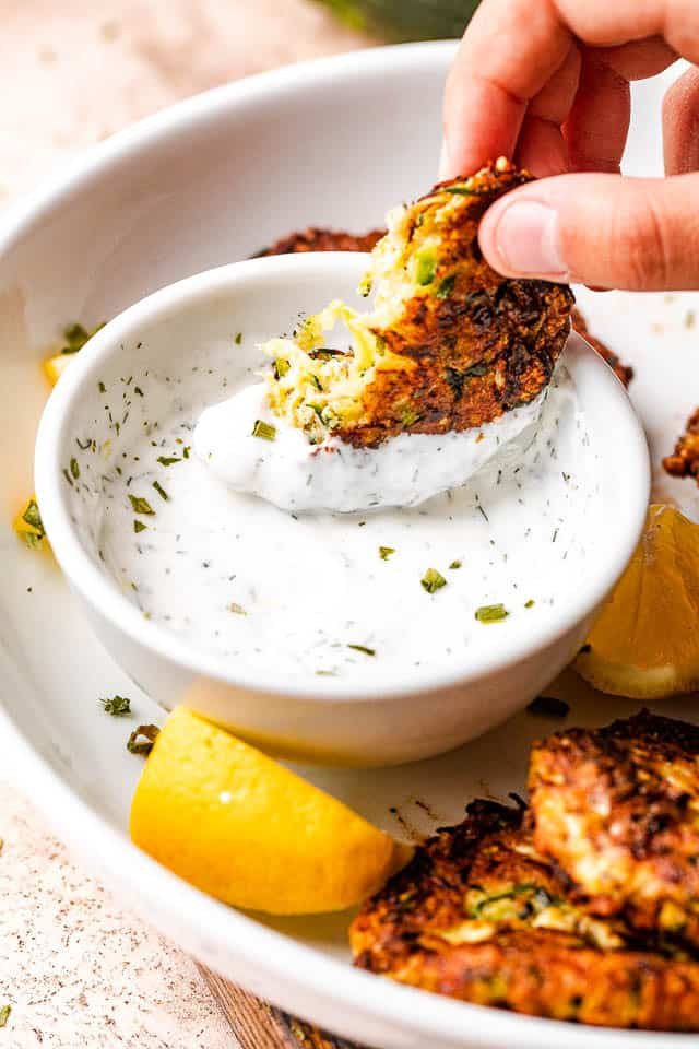 dipping zucchini cake in a yogurt dip