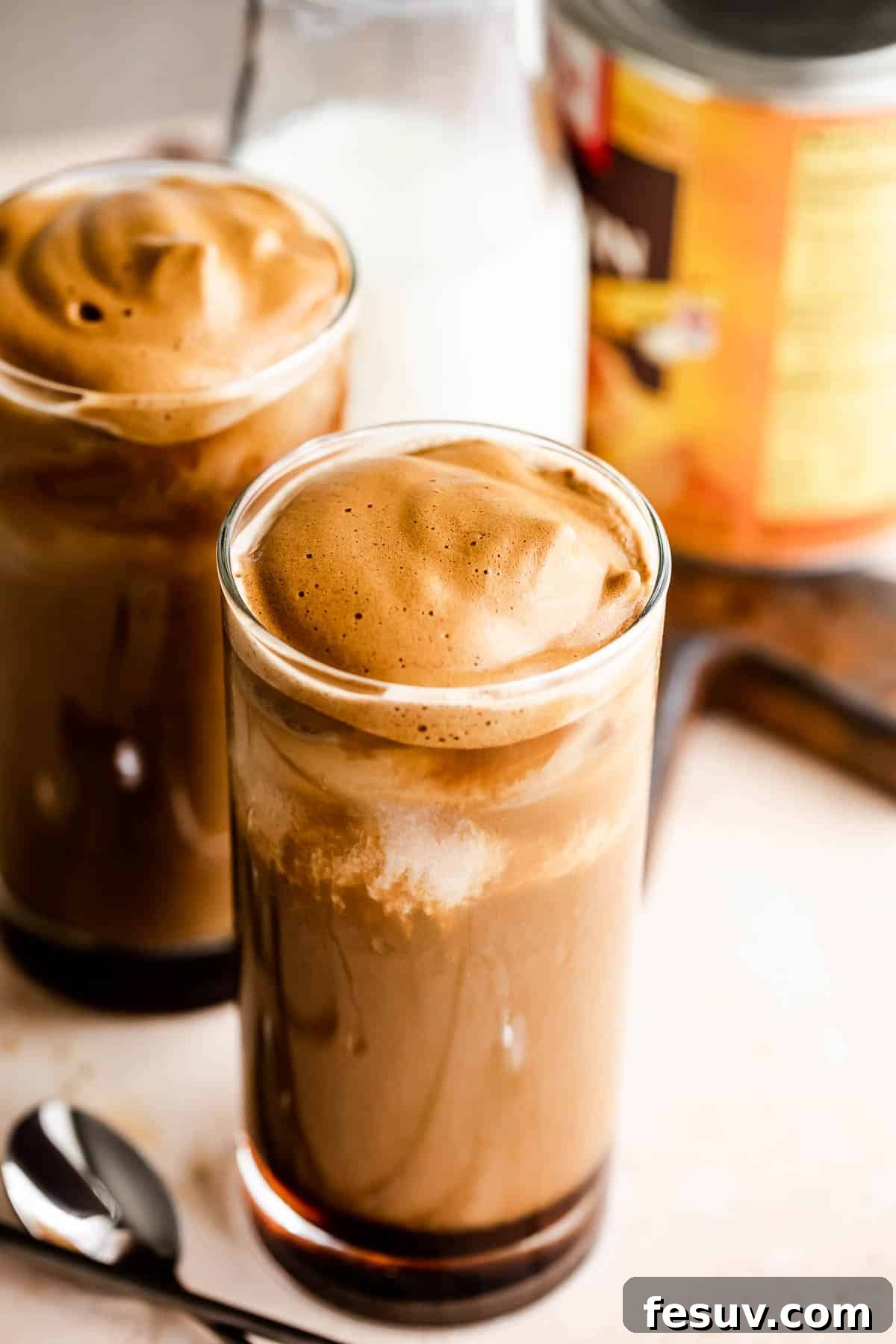 Starbucks Inspired Pumpkin Cream Cold Brew 3 Two glasses of Pumpkin Cream Cold Brew with a can of pumpkin puree nearby.