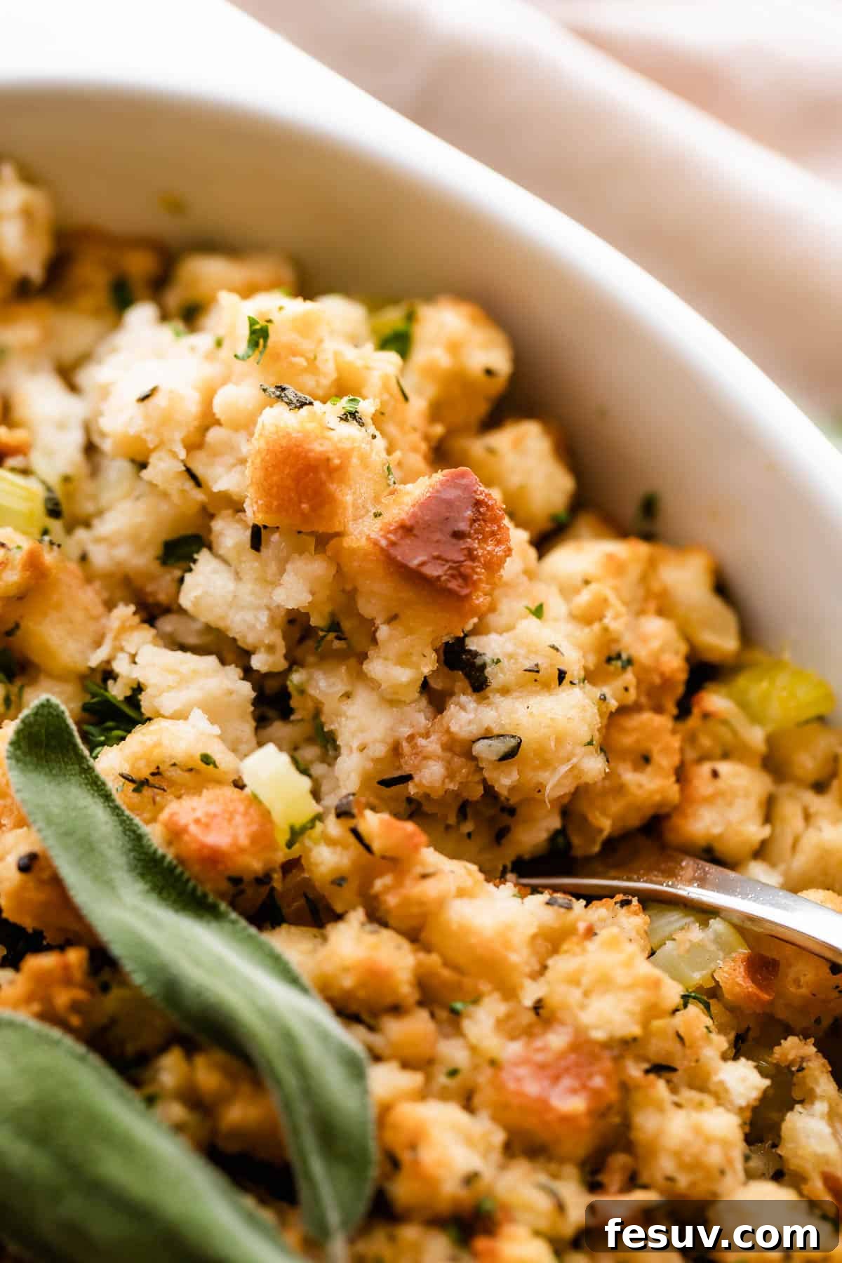A close-up shot of herb stuffing, showing the texture of the bread cubes.