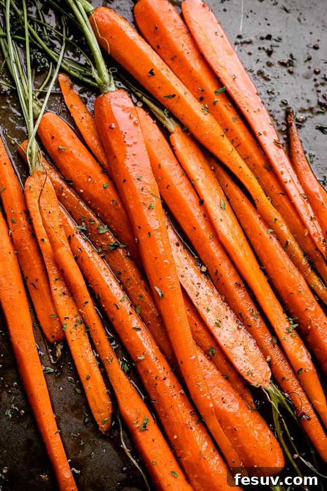 Honey Balsamic Roasted Carrots: A vibrant and delicious addition to any meal. A baking sheet filled with honey balsamic roasted carrots, garnished with fresh parsley.