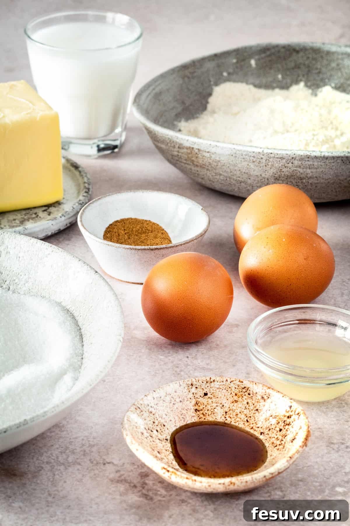 Clockwise from top left: Butter, buttermilk, nutmeg, eggs, flour, lemon juice, vanilla, sugar.