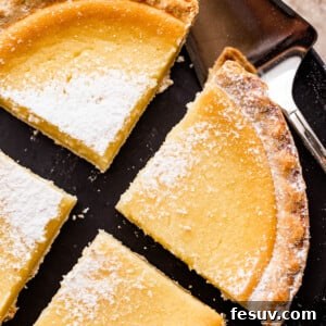overhead shot of buttermilk pie cut into 4 slices and dusted with powdered sugar.