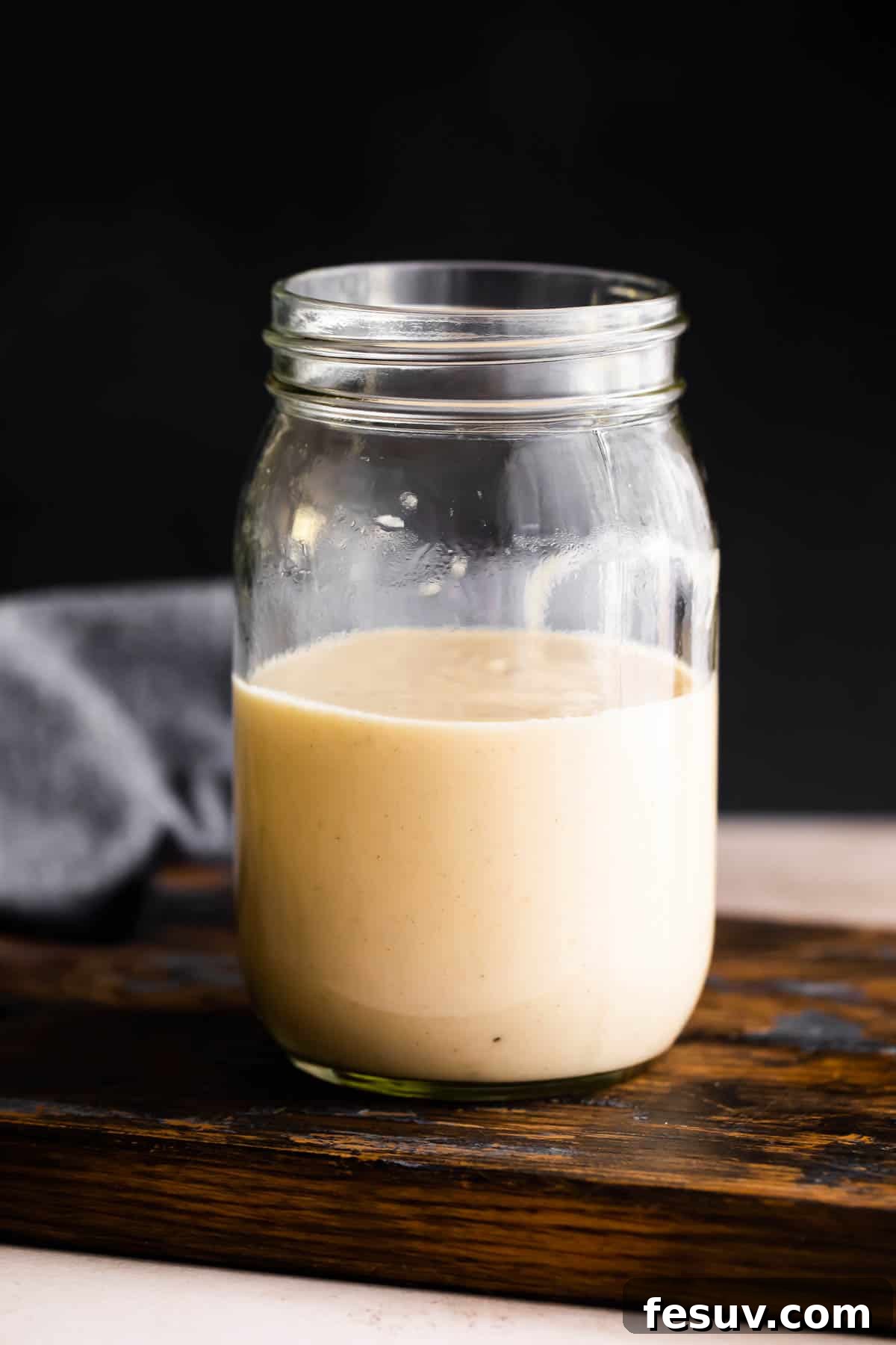 glass jar filled halfway up with homemade cream of chicken.