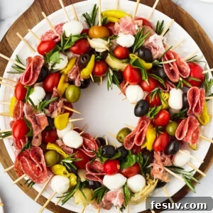 A table with a cutting board holding a wreath of skewers, a small pair of scissors, and fresh rosemary sprigs.