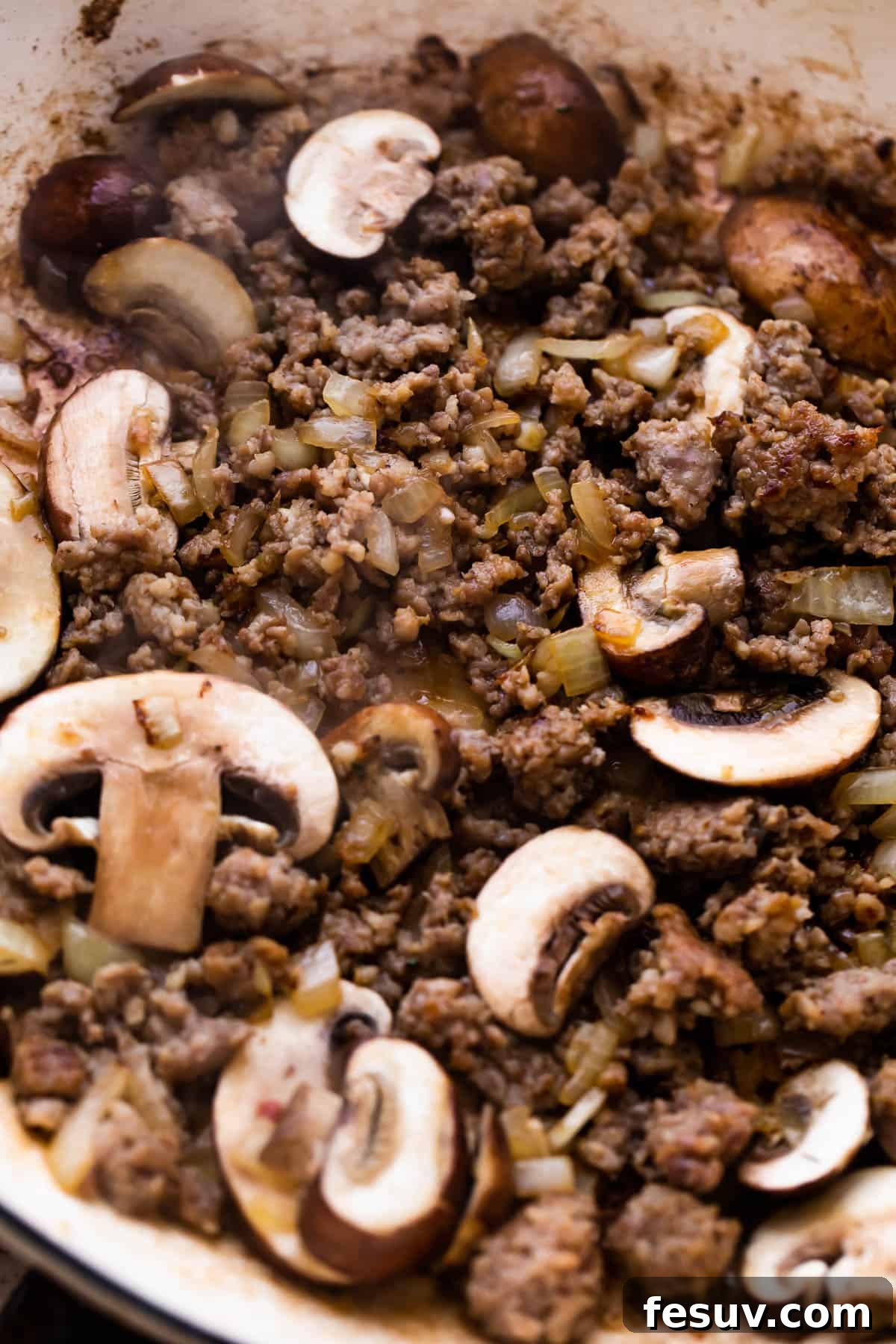 cooking ground beef with mushrooms to make beef stroganoff.