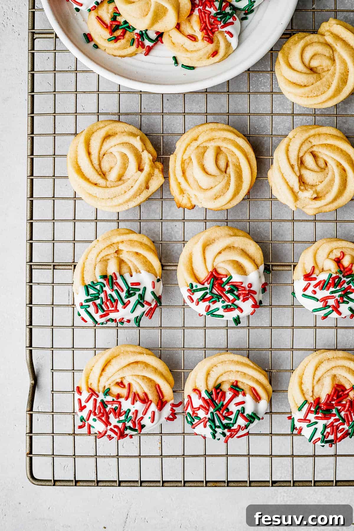 Decorated cookies drying on a cookie rack.