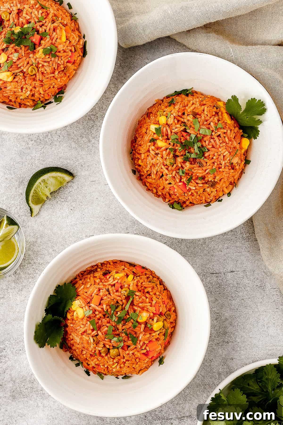 A serving of Instant Pot Mexican rice in a white bowl, elegantly garnished with fresh cilantro leaves.