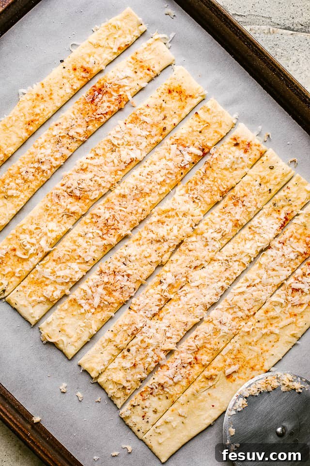 These cheese sticks are addictive movie snacks and great party food ideas! Crunchy puff pastry, melty cheesy and your favorite spices - YUM! Puff pastry layered with spices and cheese, then sliced.