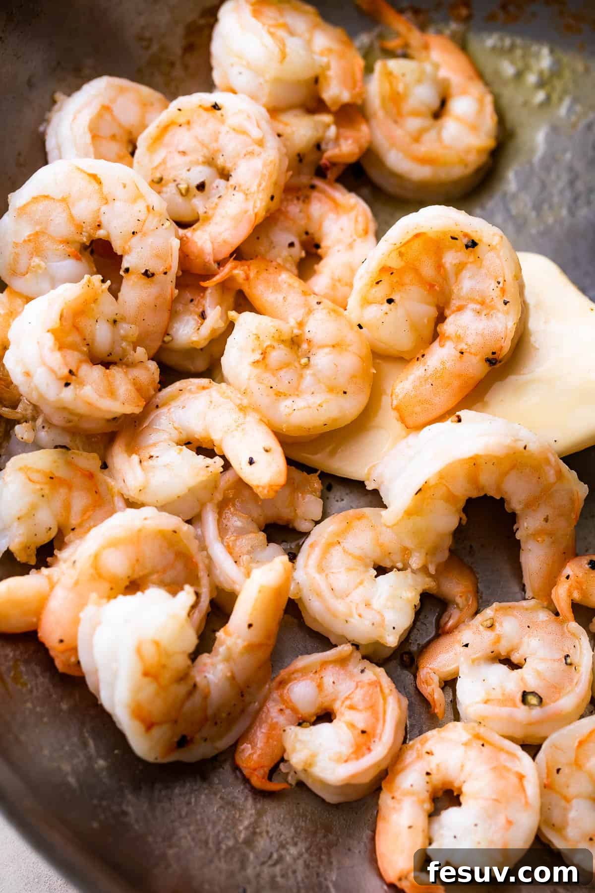 Velvet Parmesan Gnocchi with Succulent Shrimp 4 cooking shrimp in a skillet