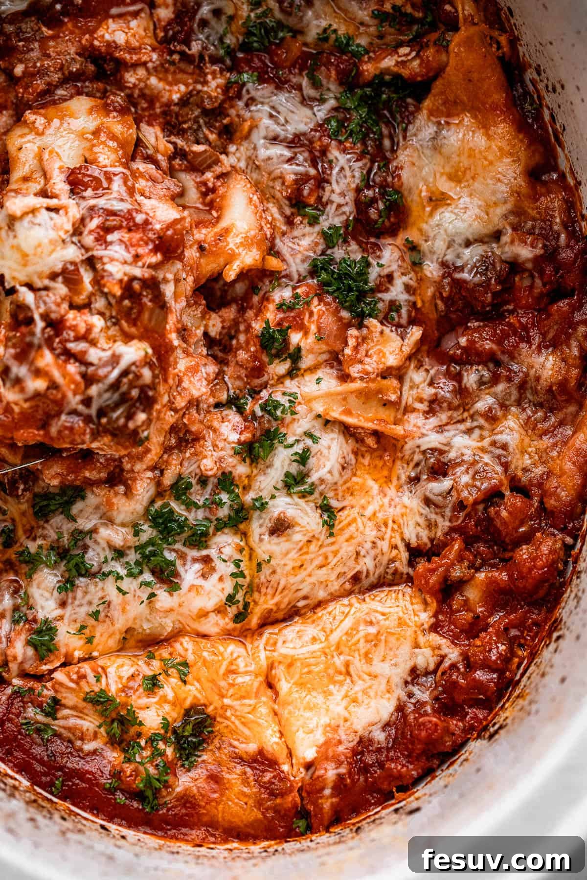 Low and Slow Lasagna Feast 3 overhead shot of a lasagna inside a slow cooker pot.