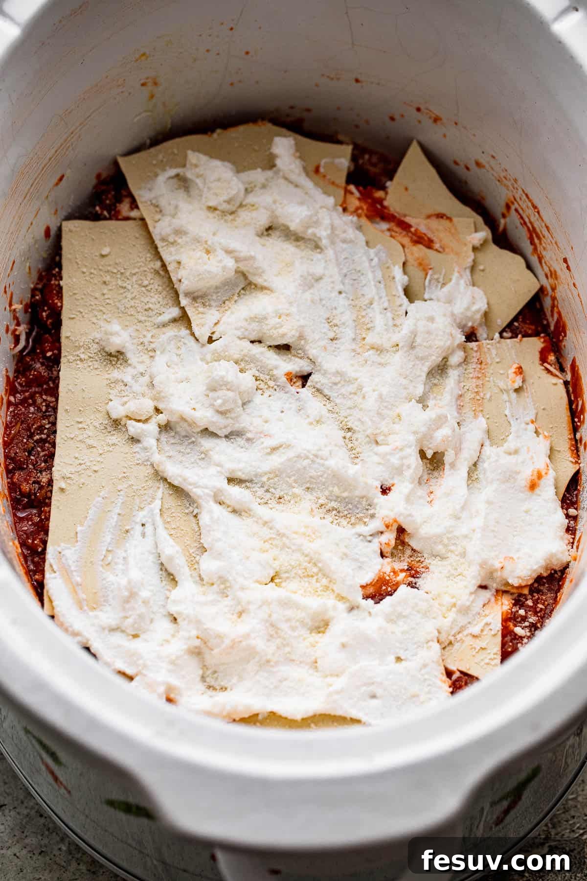 Low and Slow Lasagna Feast 5 layers of tomato sauce, lasagna noodles, and ricotta cheese inside a slow cooker insert