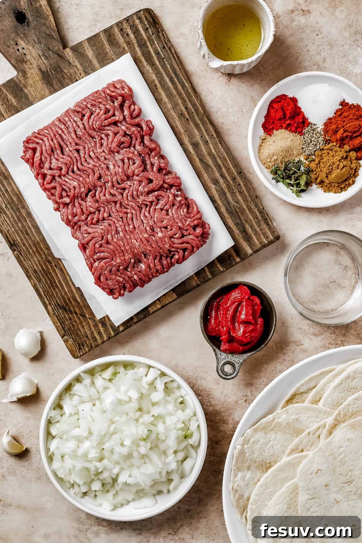 From top left: Ground beef, oil, spices, water, tomato paste, chopped onions, tortillas.