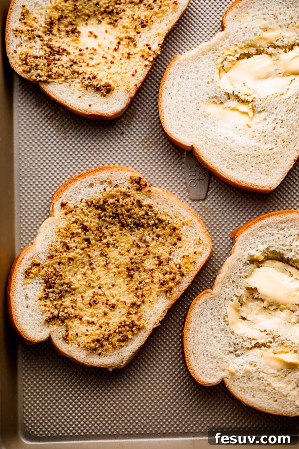 Sheet Pan Grilled Cheese Perfection 4 Four slices of bread, generously spread with a creamy mixture of Dijon mustard and mayonnaise, ready for cheese.