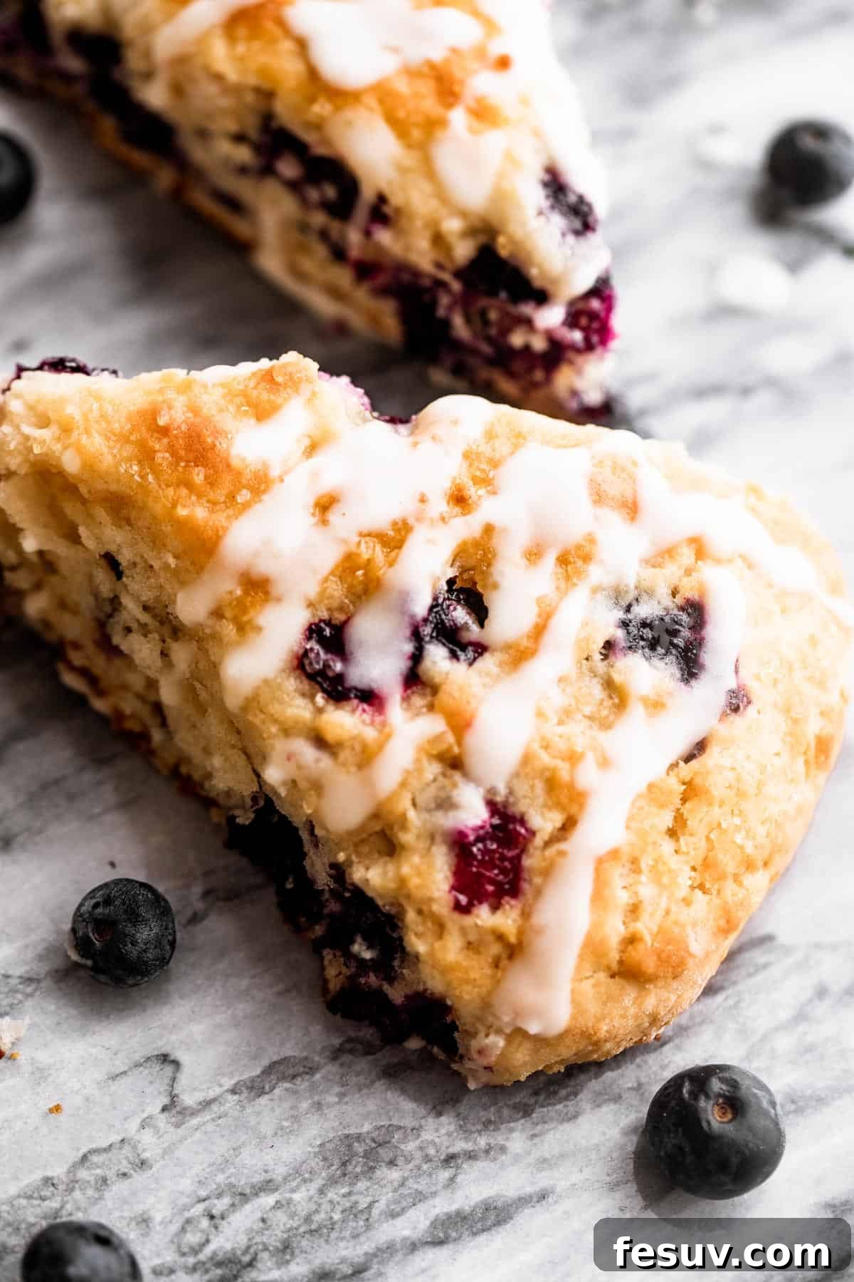 Deliciously moist and easy-to-make Blueberry Scones with real, wholesome ingredients. blueberry scones drizzled with icing