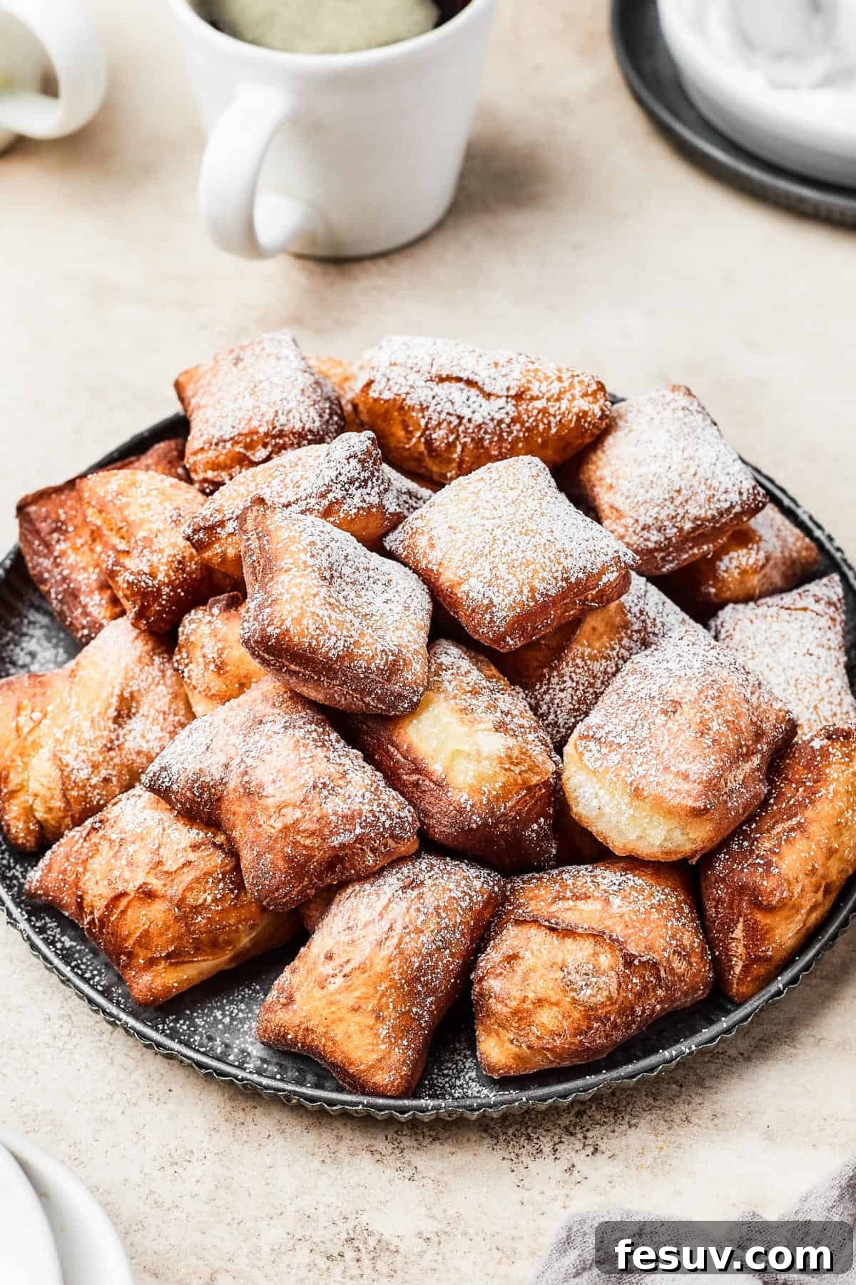 French Quarter Powdery Delights 2 A plate of fried beignets, dusted with powdered sugar.