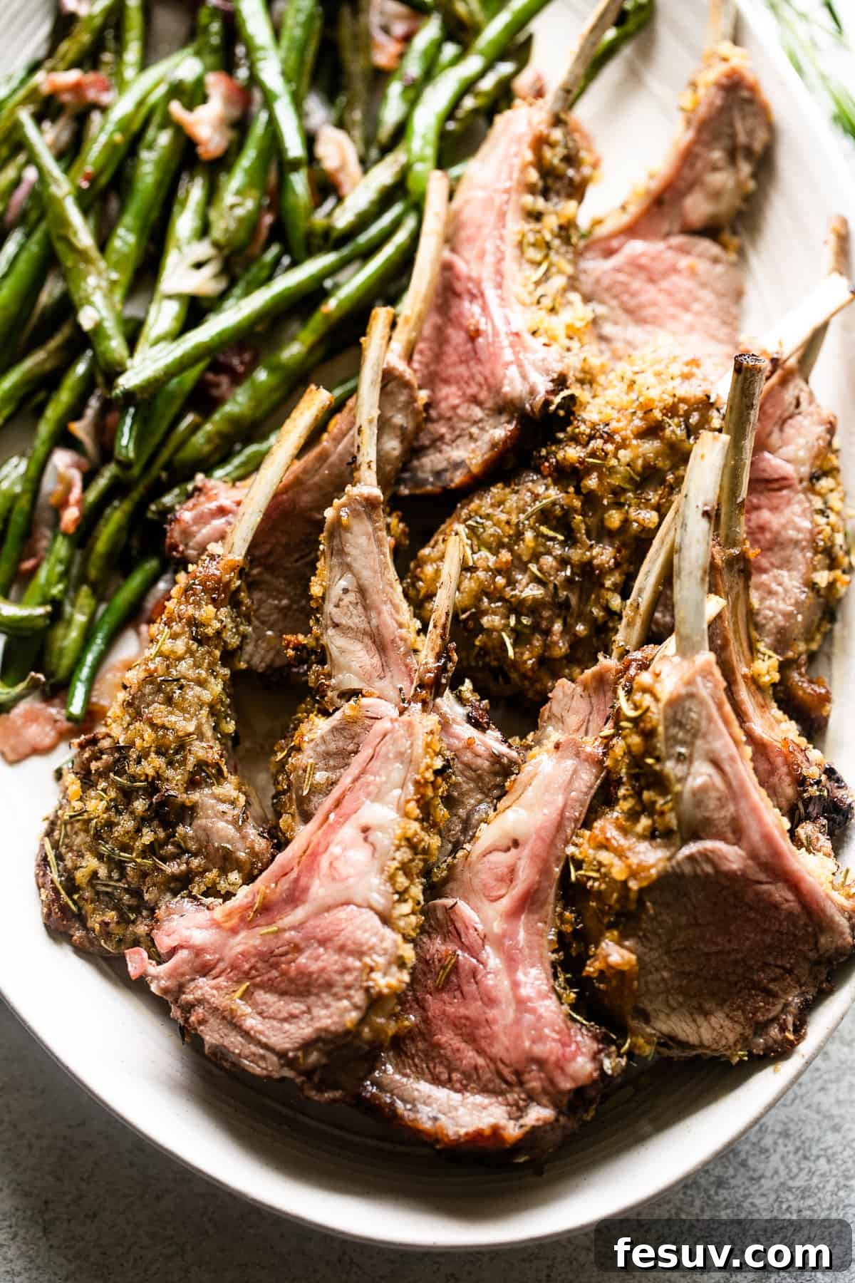 Elegant Herb-Crusted Lamb Rack 3 Close-up shot of individual breadcrumb-coated lamb chops, artfully arranged on a serving platter with a fresh side of green beans.