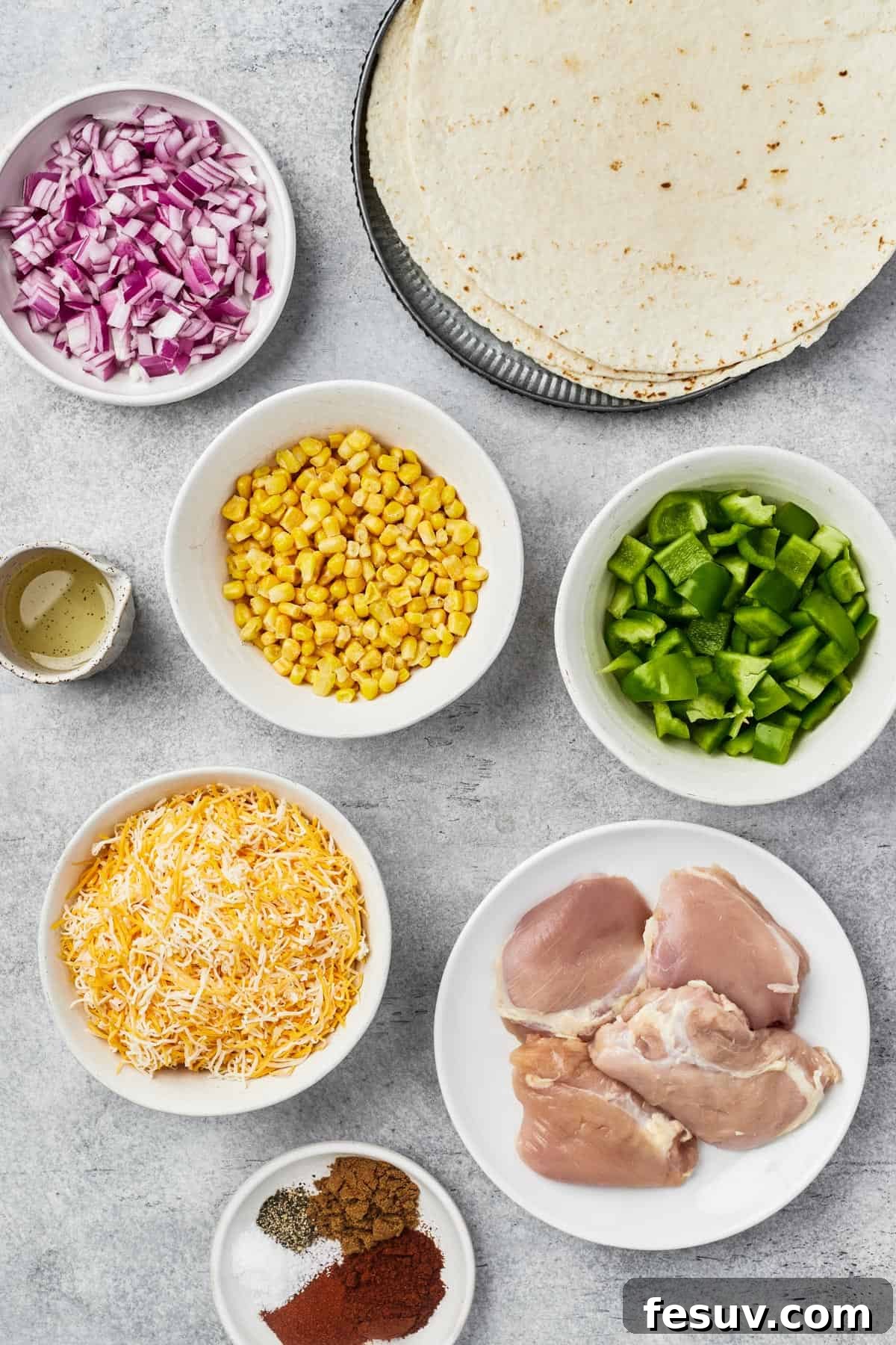 From top left: Red onion, tortillas, oil, corn kernels, bell pepper, cheese, chicken thighs, spices.