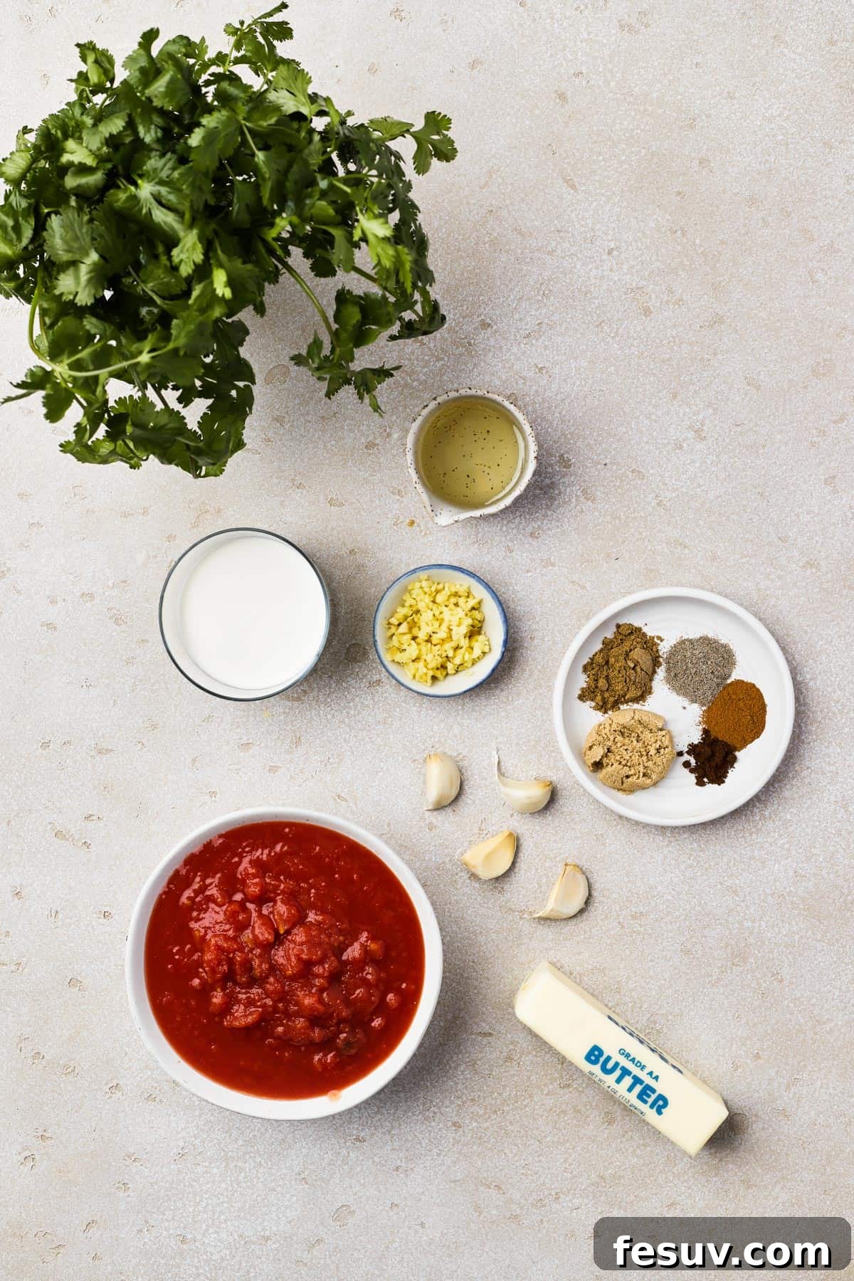 From top left: Cilantro, vegetable oil, heavy cream, minced ginger, spices, garlic, crushed tomatoes, butter.