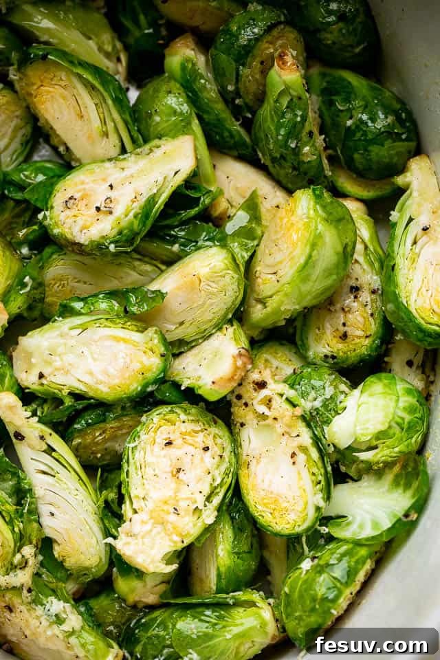 Fresh Brussels sprouts, meticulously cut in half and seasoned, ready for the slow cooker.