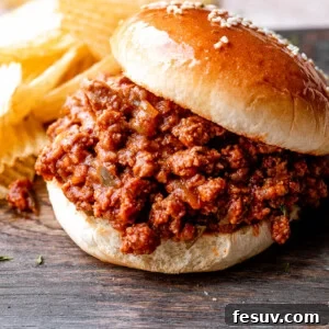 sloppy joe hamburger placed on a wooden board