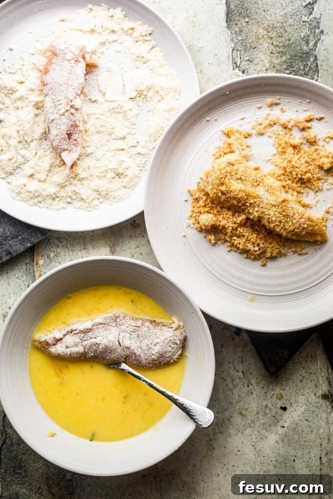 Restaurant Quality Crispy Air Fryer Chicken 4 Bottom left: Raw chicken tender soaking in a bowl with whisked eggs. Upper left: Raw chicken tender in a bowl with all-purpose flour. Right side: Raw chicken tender in pork rind breading, illustrating the breading process.