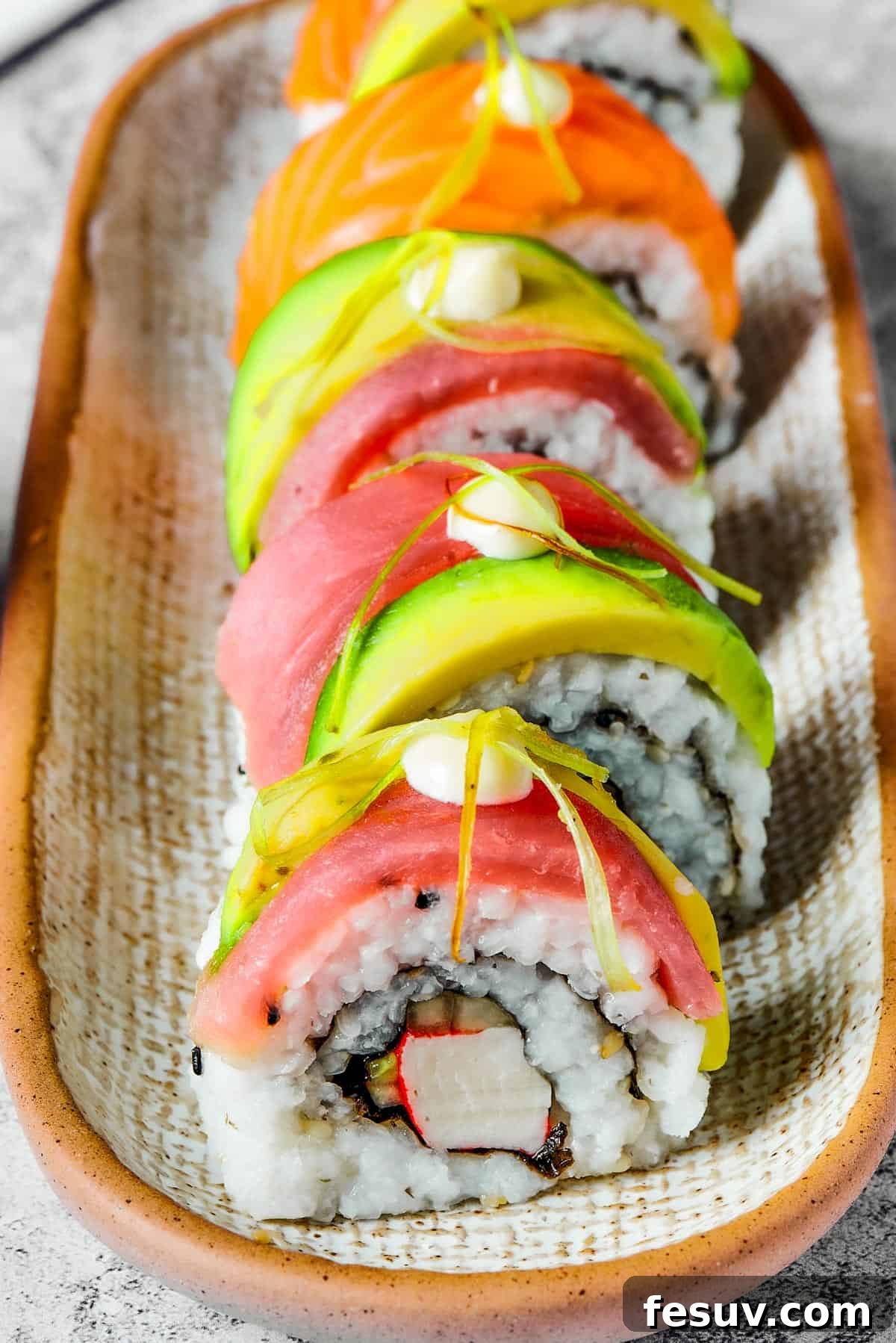Rainbow Sushi Masterpiece 3 A narrow plate with five pieces of sushi lined up on it.