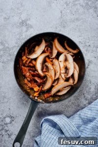 Beef and mushrooms in a skillet.
