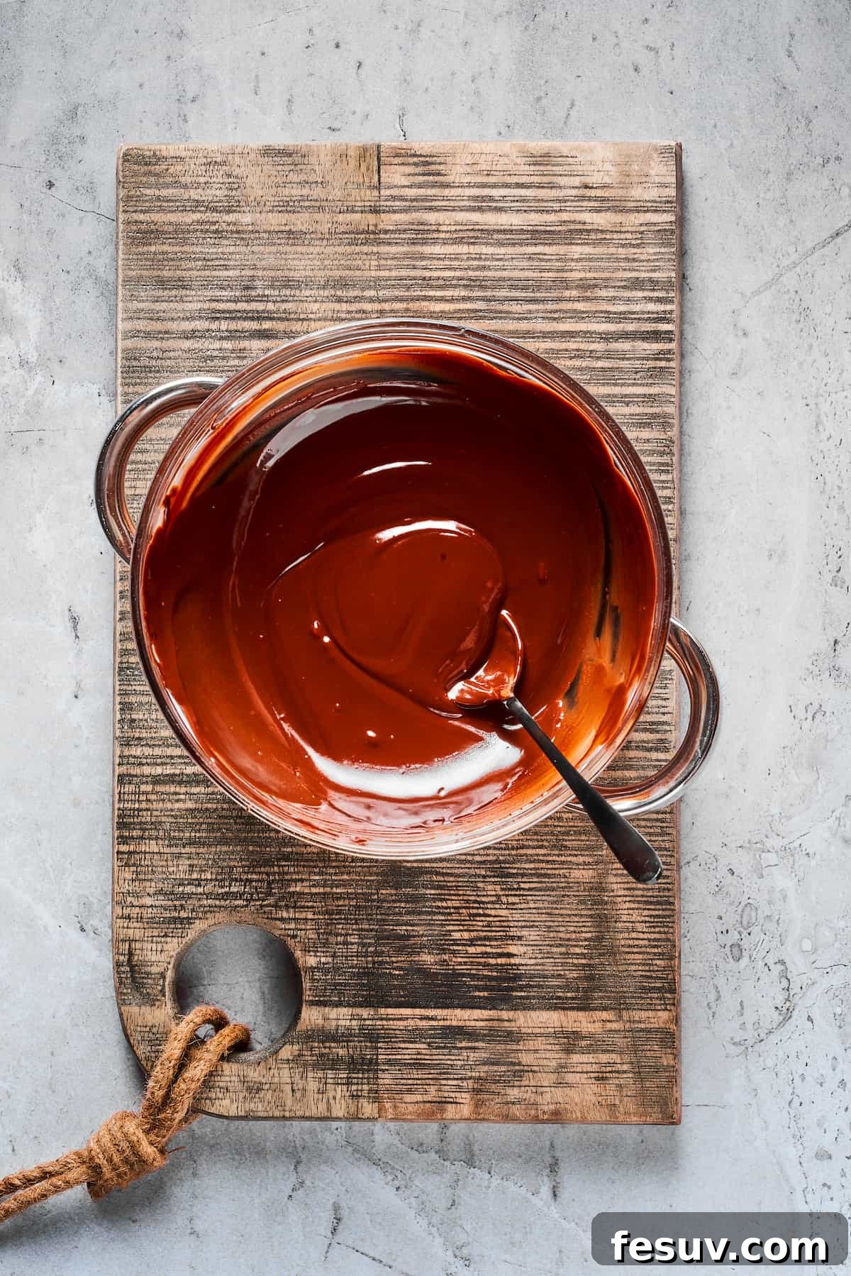 Perfectly Melted Chocolate for Dipping A bowl filled with rich, glossy melted dark and milk chocolate, ready for dipping. The chocolate has a smooth, fluid consistency.