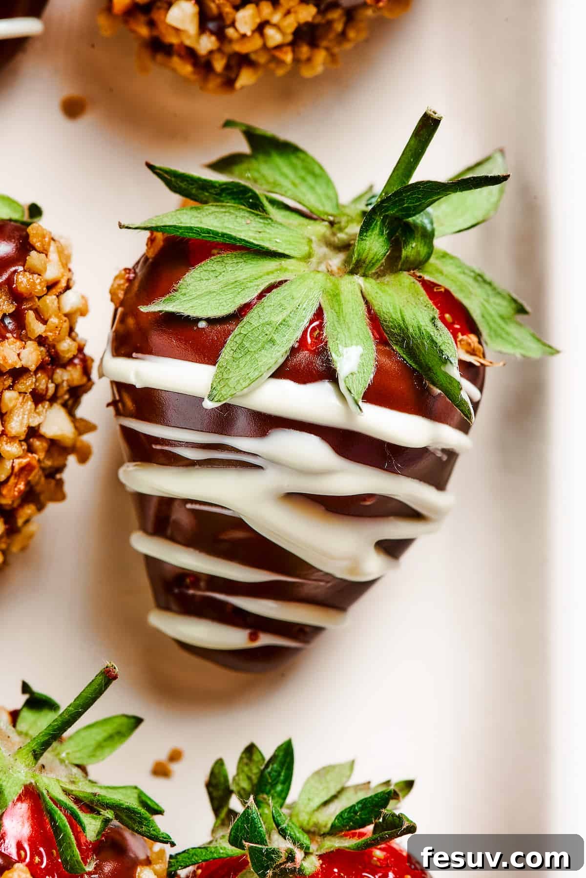 Chocolate Dipped Strawberry with White Chocolate Drizzle A single luscious strawberry, perfectly dipped in dark chocolate and elegantly adorned with a delicate drizzle of white chocolate, showcasing a classic decoration technique.
