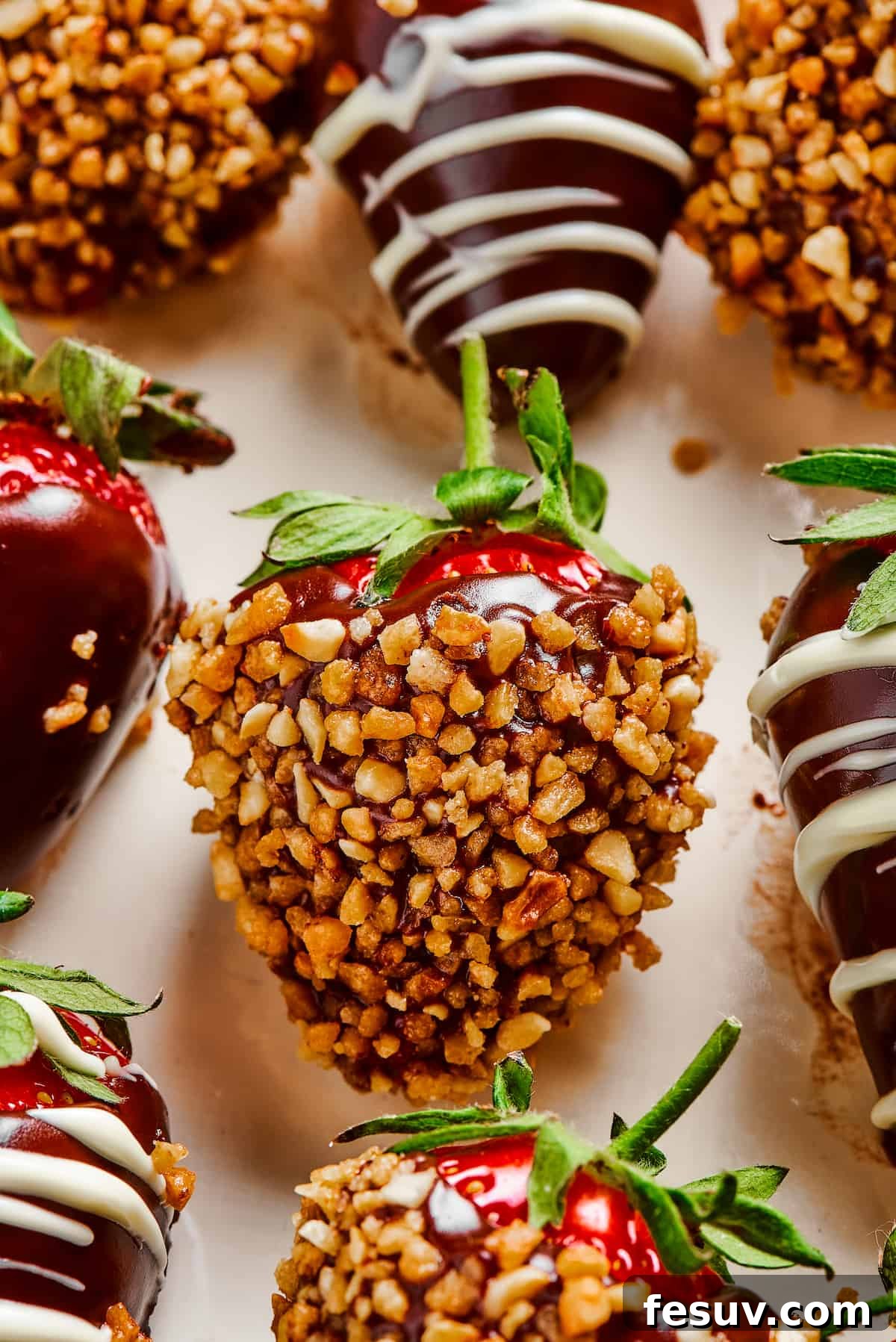Chocolate Dipped Strawberry with Nut Coating A single perfectly dipped strawberry, generously coated in crunchy chopped nuts, highlighting a popular topping variation.
