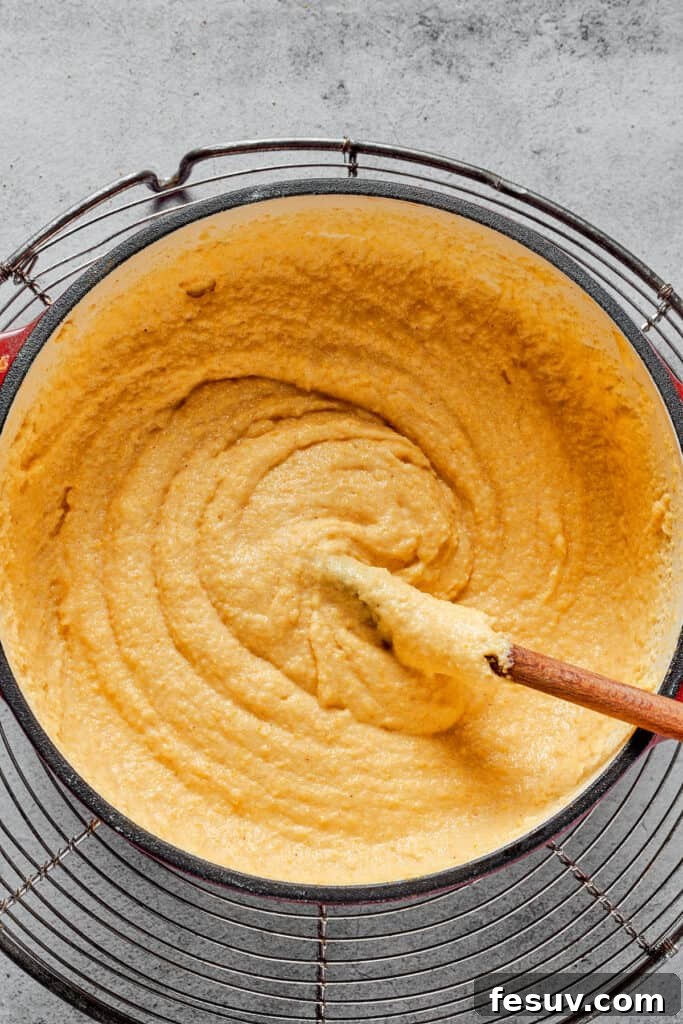 A Dutch oven filled with thick, creamy semolina batter, ready for the next steps.