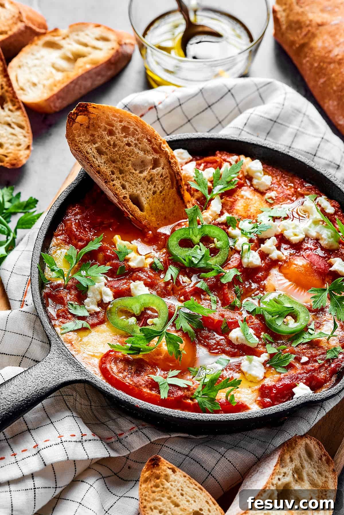The Ultimate Shakshuka 3 Homemade eggs in spicy tomato sauce.