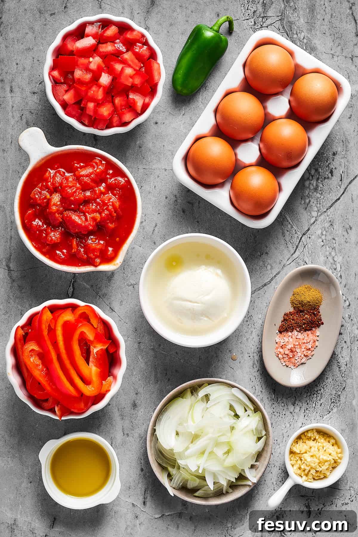 The Ultimate Shakshuka 4 From top left: Chopped fresh tomatoes, a jalapeno pepper, brown eggs, canned crushed tomatoes, fresh mozzarella, seasonings, sliced bell pepper, sliced onion, garlic, olive oil.