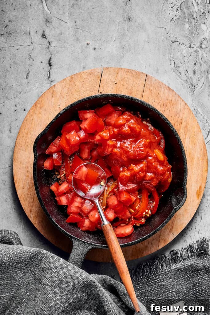 The Ultimate Shakshuka 8 Tomatoes, bell pepper, and onion in a skillet.