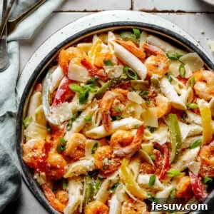 A skillet of Rasta pasta on a countertop, ready to be served, showcasing its vibrant colors and creamy texture.