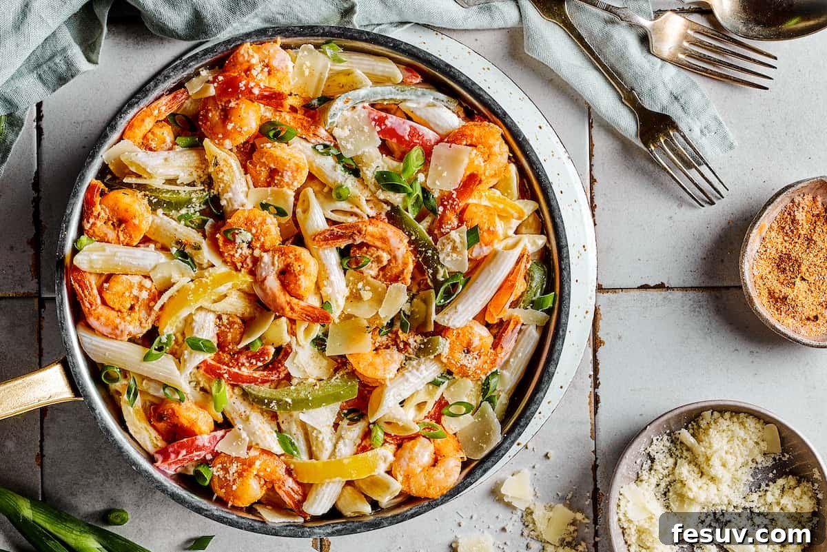 A skillet dinner of creamy Rasta pasta with shrimp and bell peppers, perfectly cooked and ready to be served.