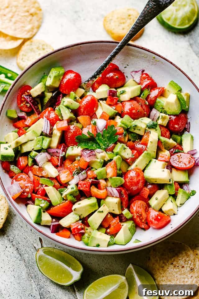 Generous Bowl of Homemade Creamy Avocado Salsa A large salad bowl filled with freshly made, vibrant avocado salsa, ready to be served.