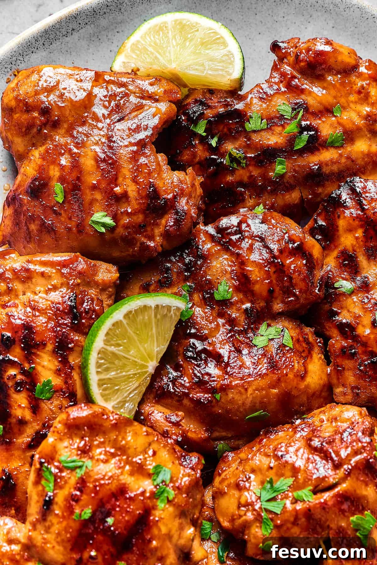 Golden-brown grilled chicken thighs coated in a sticky, savory sauce, ready to serve.