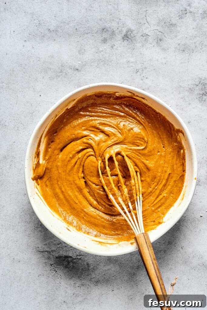 Cream Cheese Swirl Pumpkin Muffins 4 Pumpkin muffin batter in a mixing bowl.