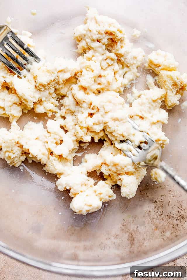 These homemade Swedish meatballs are bite size balls of beef and pork smothered in a rich, creamy gravy. A comforting and belly warming meal! Shredded bread slices soaking in milk in a bowl for the meatball mixture