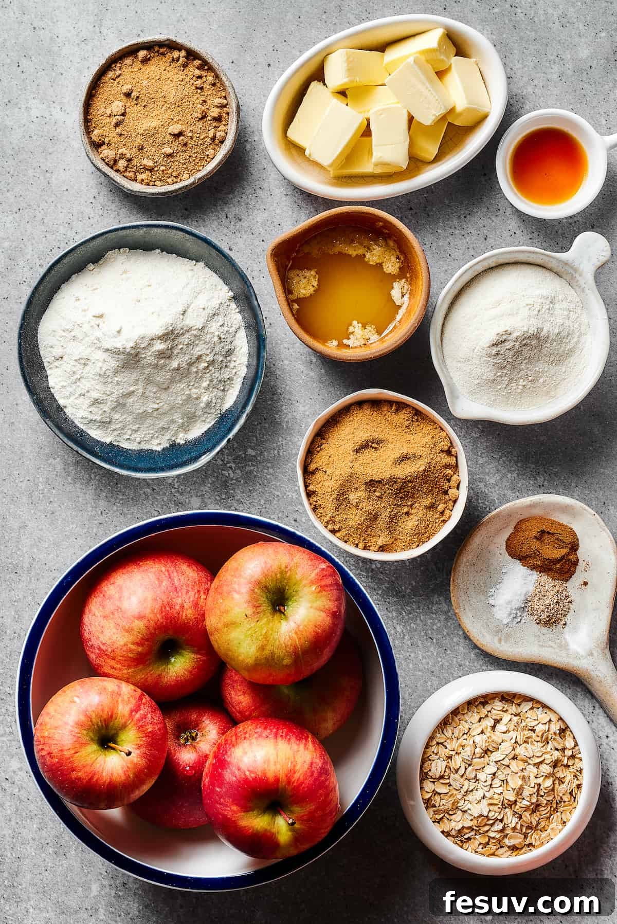 A visual guide of ingredients laid out: brown sugar, butter, vanilla extract, all-purpose flour, melted butter, more flour, more brown sugar, an assortment of warm spices, fresh apples, and rolled oats.