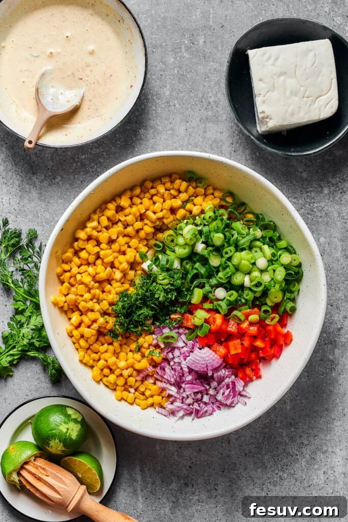 Zesty Mexican Street Corn Salad 4 Elote salad ingredients in a bowl before dressing.